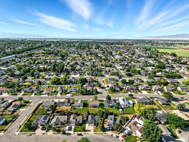 Aerial overview of property's location featuring mountains and nearby suburban area | Image 34