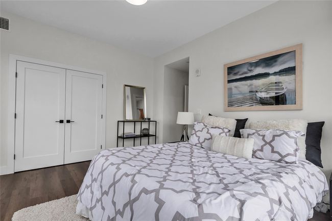 Bedroom featuring dark wood-type flooring and a closet | Image 21