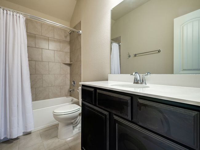 2nd Full Bath featuring toilet, tile patterned flooring, shower / tub combo with curtain, and vanity | Image 8