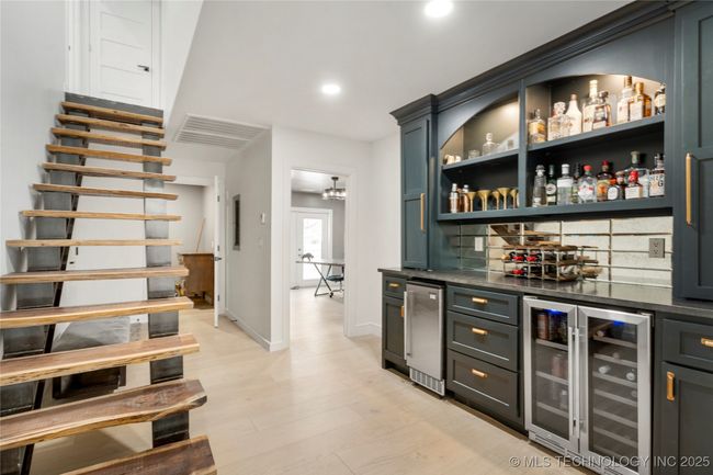 Wet bar and custom staircase to the upstairs | Image 35