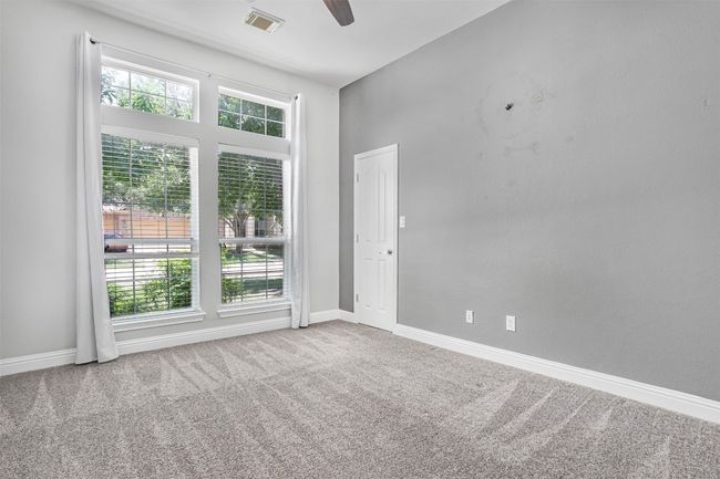 Unfurnished room with plenty of natural light, a ceiling fan, carpet flooring, and baseboards | Image 22