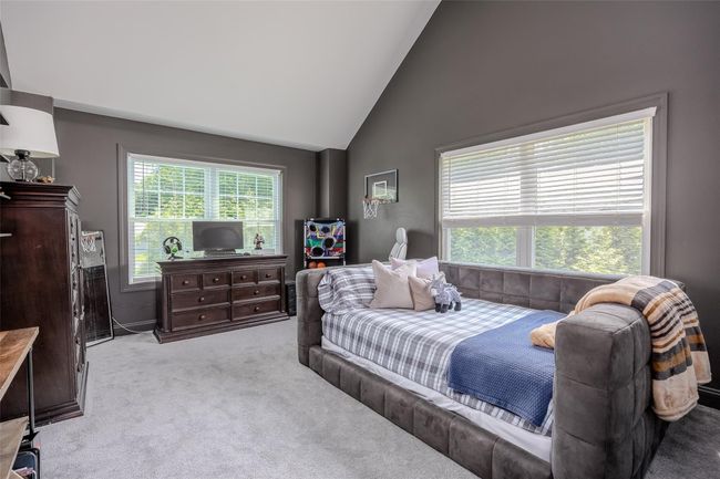 Carpeted bedroom featuring high vaulted ceiling | Image 26