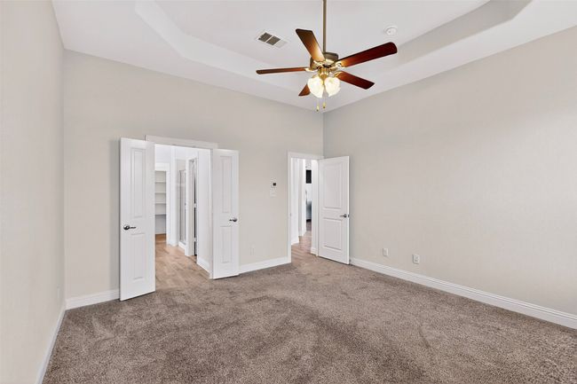 Unfurnished bedroom featuring carpet, a towering ceiling, and ceiling fan | Image 27