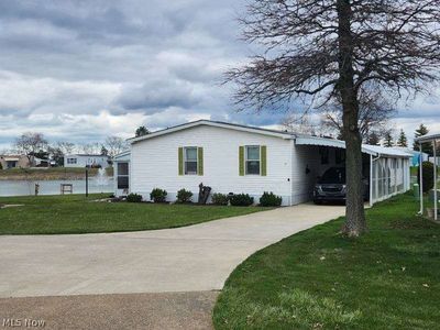 View of front of house with a carport and a front lawn | Image 2