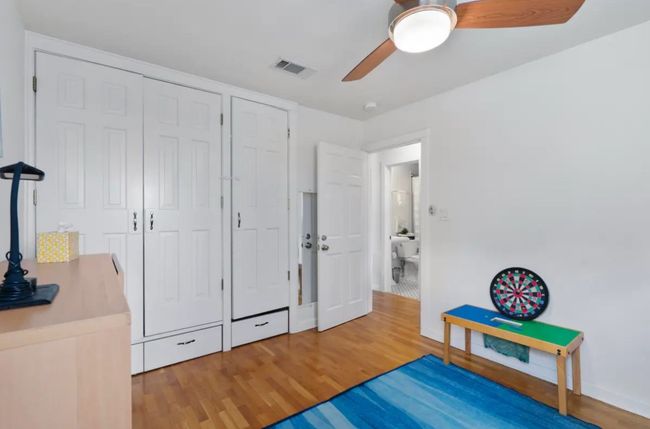 Bedroom with wood finished floors and a ceiling fan | Image 15