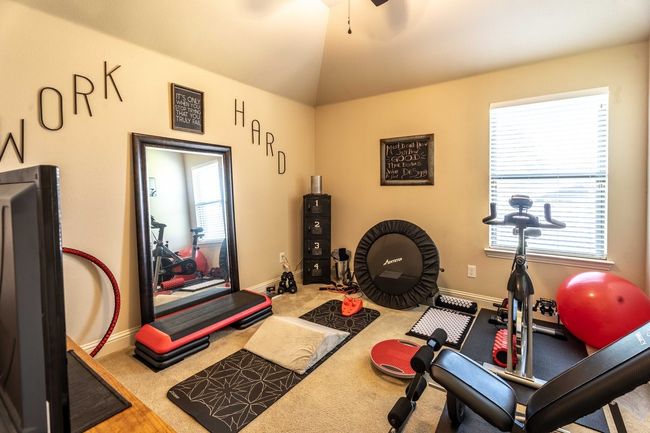 bedroom with a ceiling fan and carpet flooring use as a exercise space | Image 17