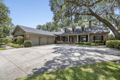 One owner custom built in 1983 with current updates. Charming all brick w/3 car garage. Located on a dead end street | Image 1