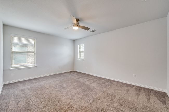 Spare room with light colored carpet and ceiling fan | Image 9