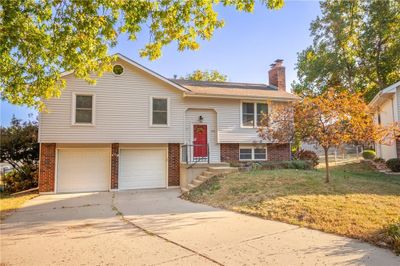 Raised ranch featuring a front yard and a garage | Image 1