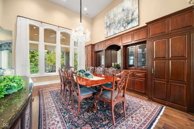 dining area with recessed lighting, an inviting chandelier, dark wood-type flooring, and a towering ceiling | Image 12