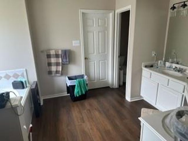 Spacious master bathroom featuring elegant fixtures, ample storage, and a sleek design perfect for relaxation and convenience. | Image 6