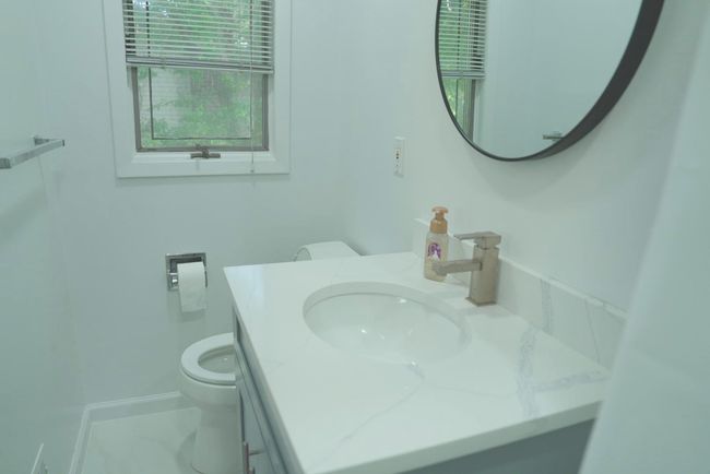Bathroom featuring vanity and toilet | Image 12