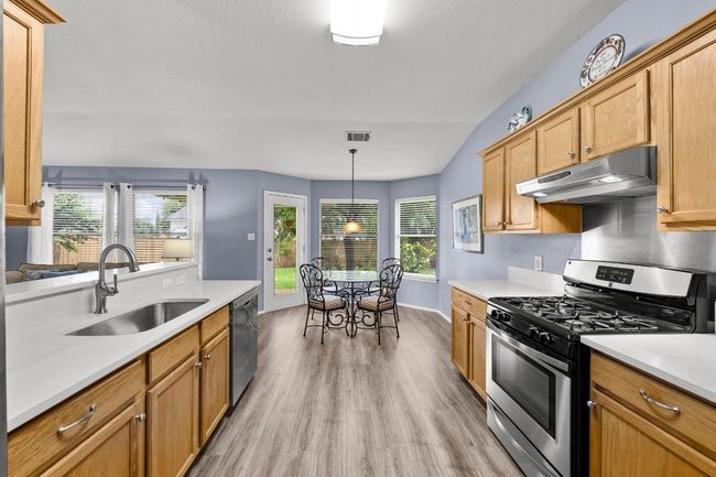 Kitchen with new quartz countertops, stainless steel appliances, gas range | Image 6