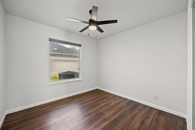 Spare room featuring dark wood-type flooring and ceiling fan | Image 15