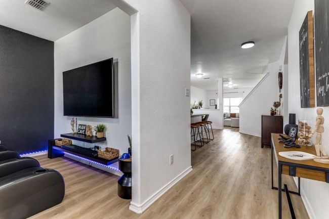 Living area with light wood-style flooring and baseboards | Image 5