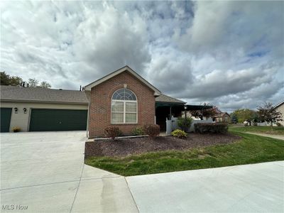 View of front of home with a garage and a front yard | Image 1