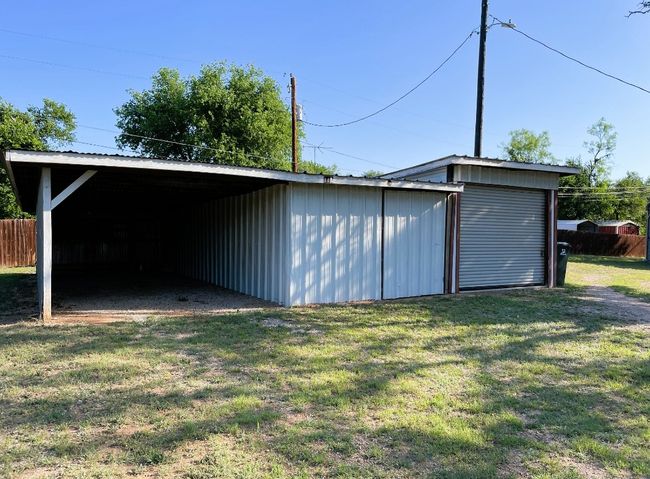 Garage with a carport and fence | Image 27