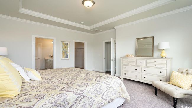 Bedroom with a closet, ornamental molding, dark carpet, ensuite bathroom, and a walk in closet | Image 19