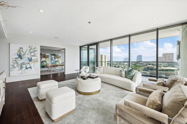 The den with views to the office located through the doorway featuring pocket doors in the case that privacy is desired. There is also access to the west and south balconies. | Image 15