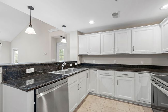 Kitchen with Solid Surface Countertops and Newly Painted Cabinets | Image 10