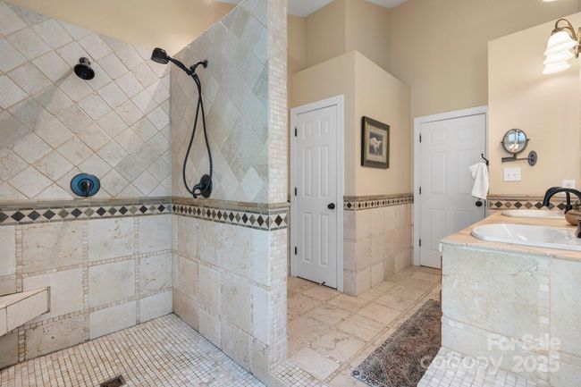 Primary bath gives access to big walk-in closet | Image 21