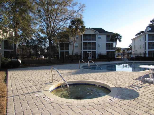 Community pool featuring a hot tub. | Image 38