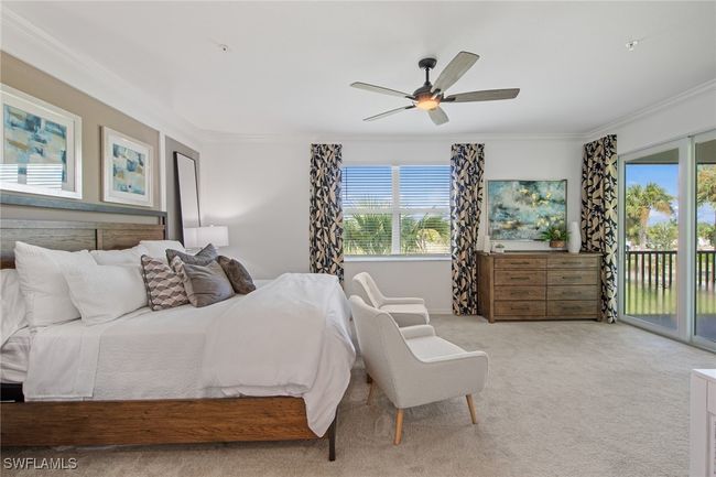Bedroom with light colored carpet, access to exterior, ornamental molding, and a ceiling fan | Image 10