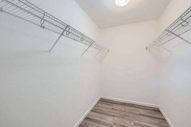 Spacious closet featuring wood finished floors | Image 23