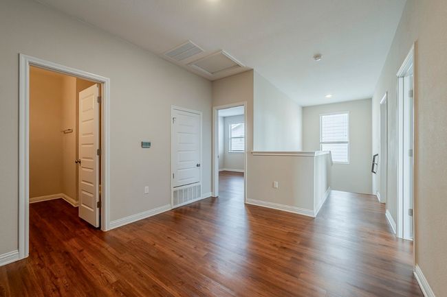 Spare room with dark wood-type flooring, attic access, baseboards, and visible vents | Image 24