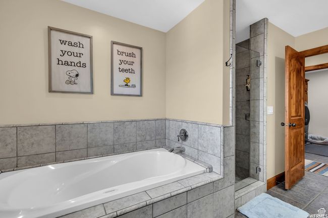 Full bath featuring a garden tub, a stall shower, and tile patterned floors | Image 25