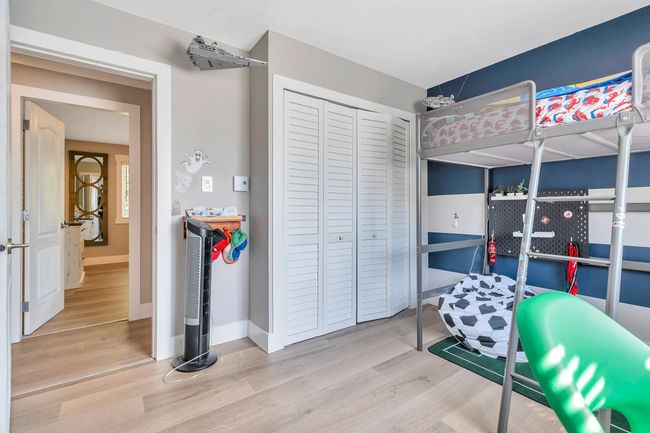 Bedroom with baseboards, wood finished floors, and a closet | Image 21