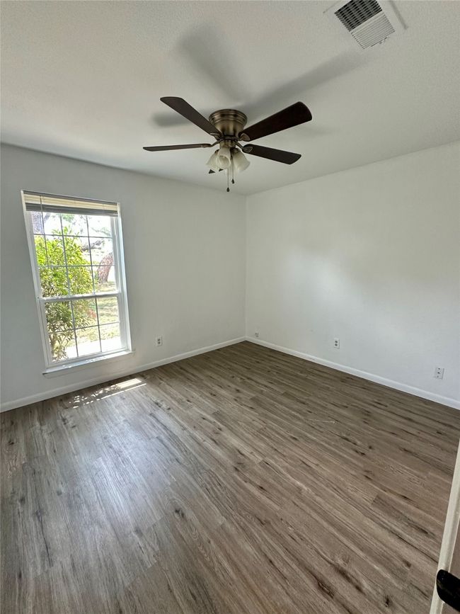 Empty room featuring a ceiling fan and wood finished​​‌​​​​‌​​‌‌​‌‌​​​‌‌​​‌‌​‌​​​​​‌ floors | Image 16