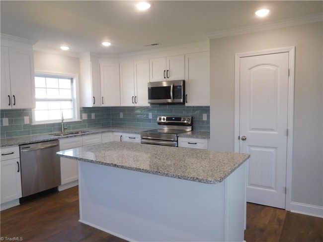 Beautiful Bright Kitchen with Granite Countertops, Tile Backsplash, under Cabinet Lights, Island and Pantry. | Image 8
