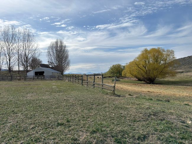 View of yard with fence, an outbuilding, and a rural view | Image 73