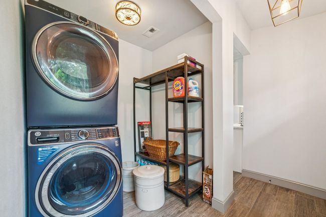 Laundry room with stacked washer and dryer | Image 28