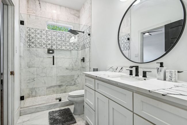 Full bathroom with marble finish floors, vanity, and a shower stall | Image 30