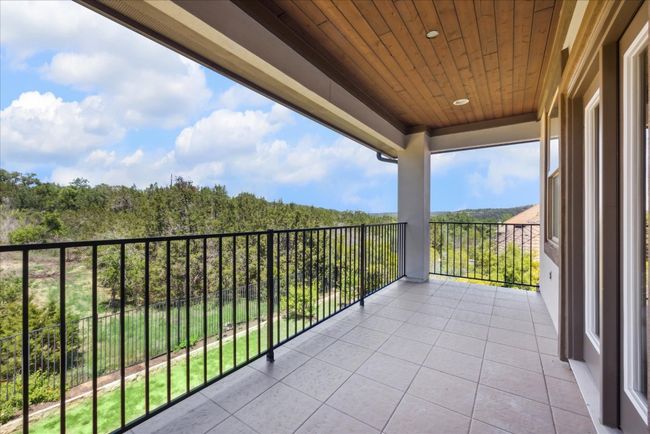 Balcony featuring a view of trees | Image 23