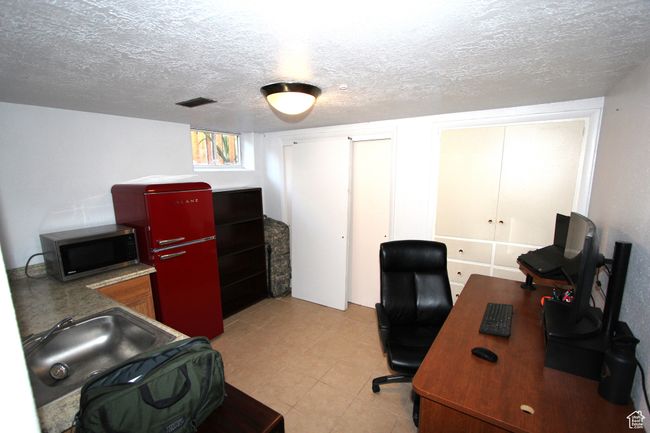Office space with a textured ceiling and light tile patterned floors | Image 25