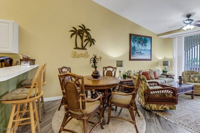 Dining area featuring wood finished floors, lofted ceiling, and a ceiling fan | Image 13