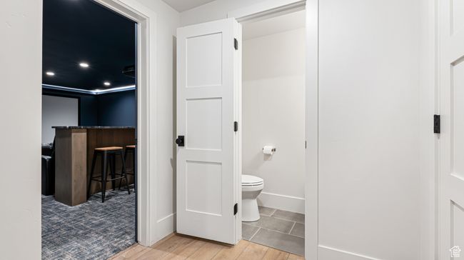 Bathroom featuring baseboards, wood finished floors, and toilet | Image 31