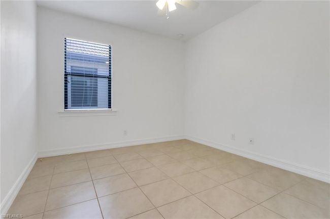 Unfurnished room featuring ceiling fan, baseboards, and light tile patterned floors | Image 13