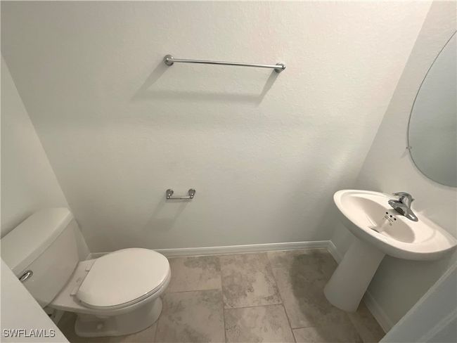 Half bathroom with baseboards and toilet | Image 6