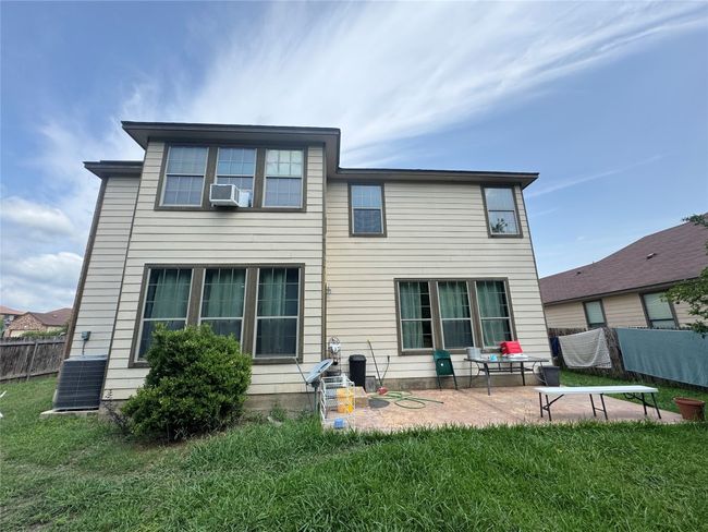 Rear view of house with a patio area and cooling unit | Image 6