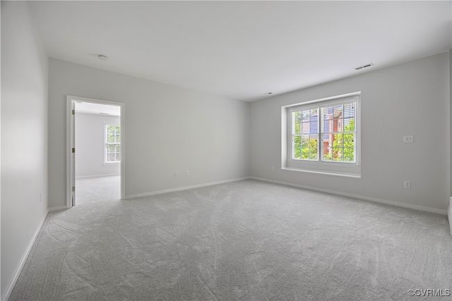 Unfurnished room featuring light colored carpet, visible vents, and baseboards | Image 26
