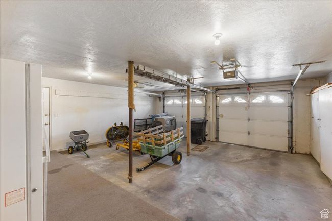 Garage with a garage door opener | Image 32