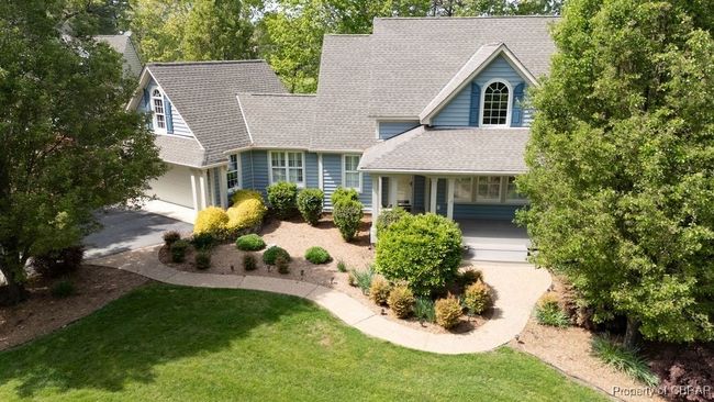 View of front of house with a shingled roof, a porch, a front lawn, and driveway | Image 6