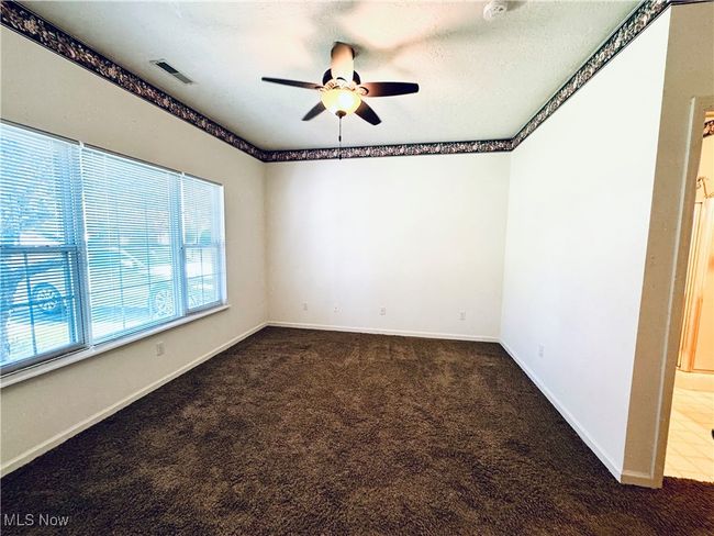 Carpeted spare room with ceiling fan, baseboards, and visible vents | Image 18