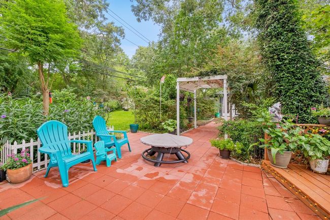 Beautiful patio continues with this bricked pathway and sitting area | Image 32