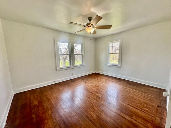 unfurnished room featuring ceiling fan, dark wood-style flooring, and baseboards | Image 34