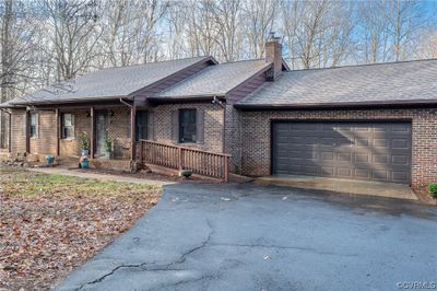 Ranch-style house with a garage and a porch | Image 2